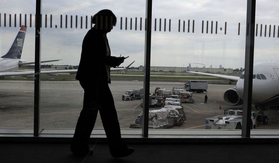 A U.S. Airways employee makes her way to a jet on Thursday, May 20, 2010, at the Philadelphia International Airport.