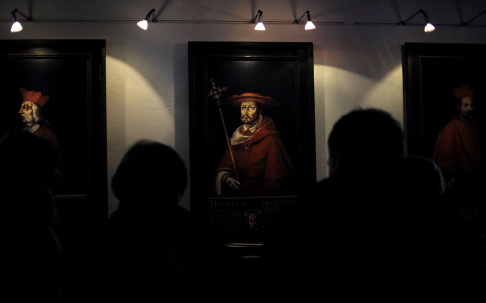 Tourists view portraits of former Archbishops of the Archdiocese of Salzburg during a tour of the Salzburg Festung (Fortress) on Friday, May 21, 2010, on Salzburg, Austria.