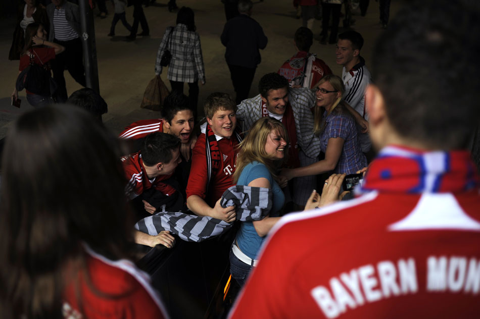 Bayern München fans pile in together for a photograph on Saturday, May 22, 2010, near downtown Munich, Germany.