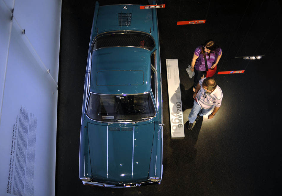 Visitors look over a 1964 BMW 700 on Monday, May 24, 2010, in the BMW Museum in Munich, Germany.