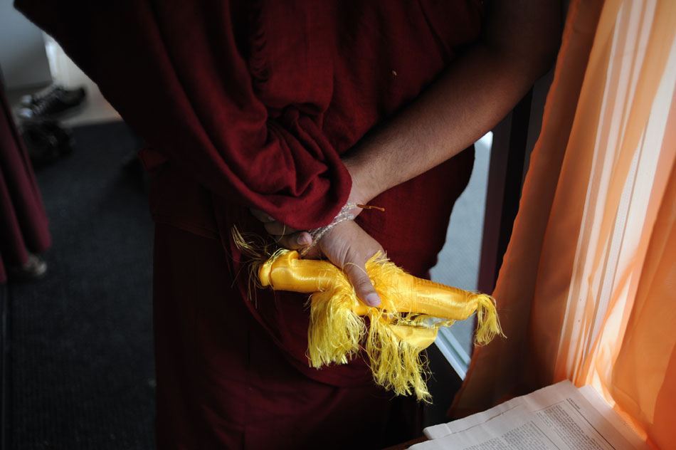 A monk holds a Khata, a ceremonial scarf, before the arrival of a dignitary on Saturday, May 8, 2010, at the Bloomington Tibetan Mongolian Buddhist Cultural Center. The center welcomed Khen Rinpoche, an abbot from a monastery in Gomang, India.