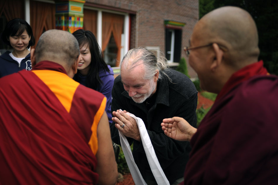 Russell Ellis, middle, presents a Khata, a ceremonial scarf, to Khen Rinpoche, an abbot from a monastery in Gomang, India, on Saturday, May 8, 2010, at the Bloomington Tibetan Mongolian Buddhist Cultural Center. The center is welcoming dignitaries in anticipation of the Dalai Lama's visit on May 12 and 13.