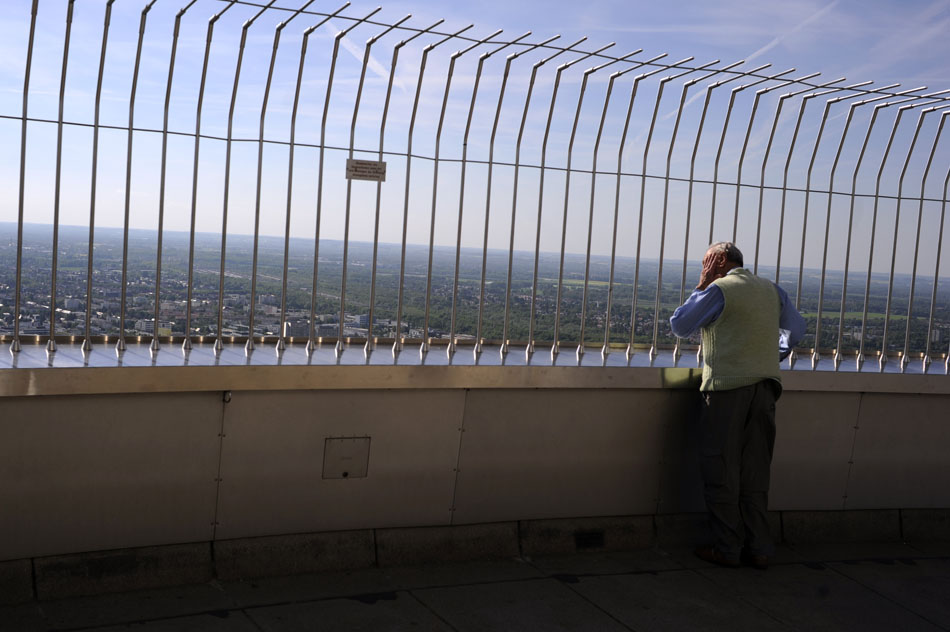 A man looks into the horizon from a viewing deck of the Olympic Tower on Monday, May 24, 2010, in Munich, Germany.