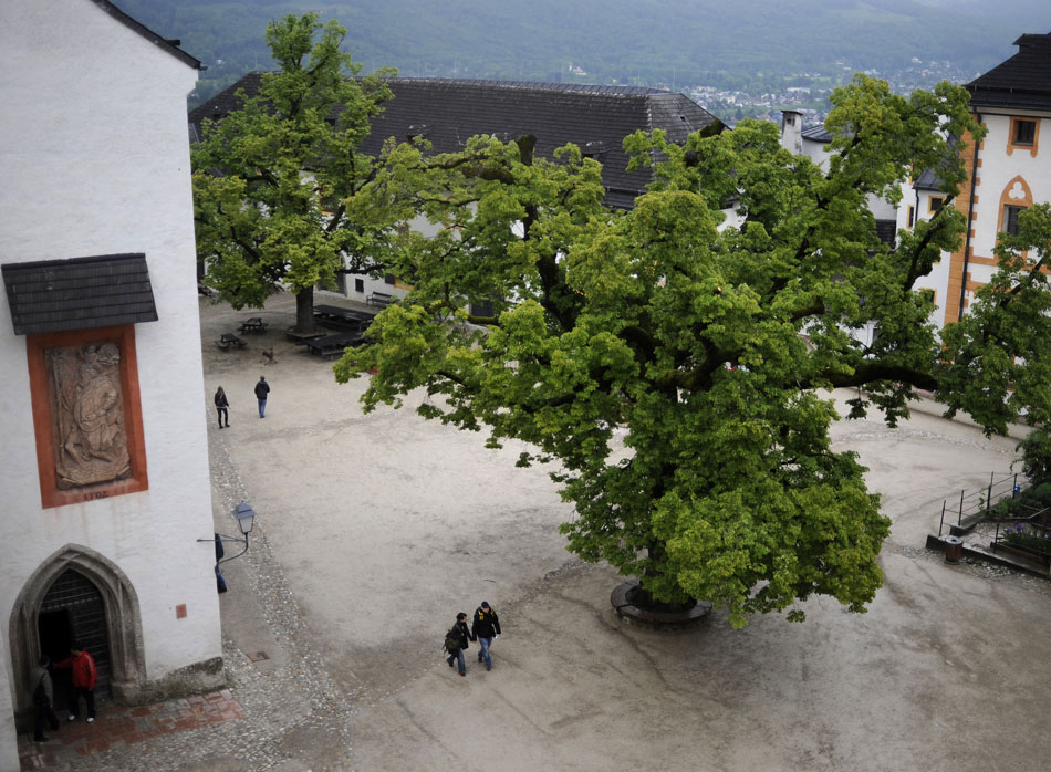 A couple, center, make their way through a courtyard atop the Salzburg Festung (Fortress) on Friday, May 21, 2010, in Salzburg, Austria.