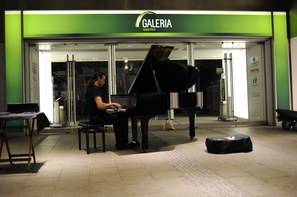 A man plays a piece of classical music on Monday, May 24, 2010, outside a shopping mall in downtown Munich, Germany.