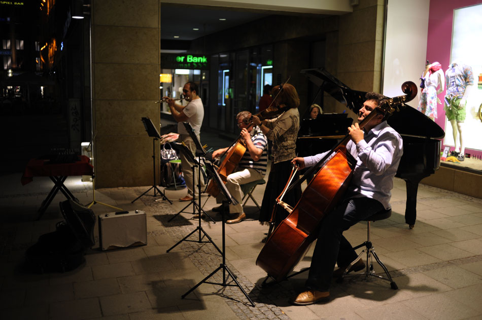 Musicians perform for pedestrians outside a clothing store on Monday, May 24, 2010, in downtown Munich, Germany.