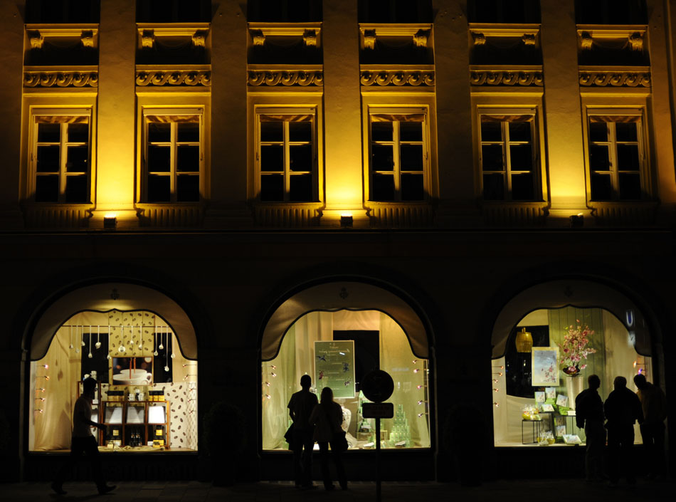 Pedestrians stop to look at window displays on Monday, May 24, 2010, outside a clothing store in downtown Munich, Germany.