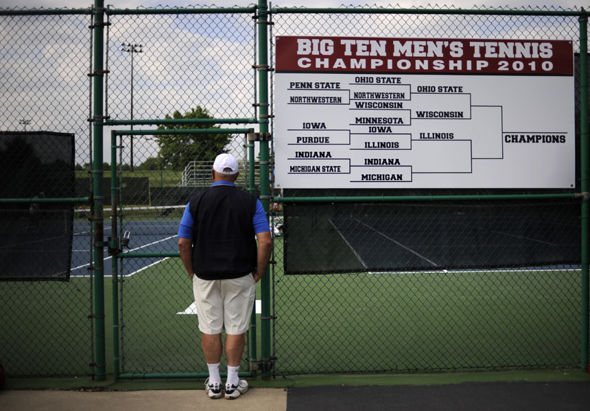 A Big Ten official watches the action as Michigan and Indiana singles players compete during the Big Ten Men's Tennis Tournament on Friday, April 30, 2010, at Indiana University in Bloomington, Ind.