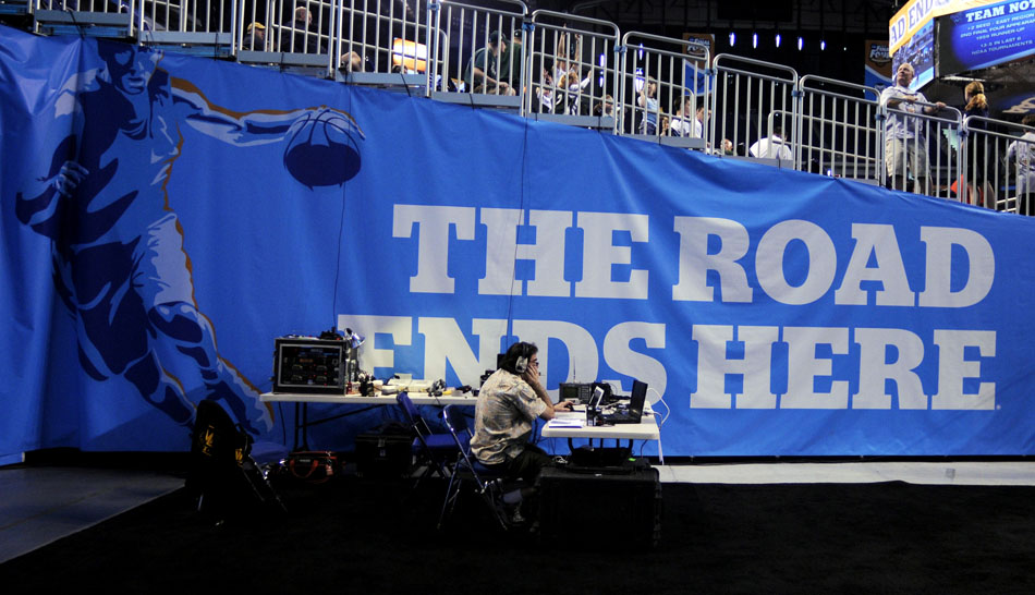 A CBS technician works off the court during West Virginia's open practice on Friday, April 2, 2010, at Lucas Oil Stadium in Indianapolis. Each of the Final Four teams held open practices for fans.