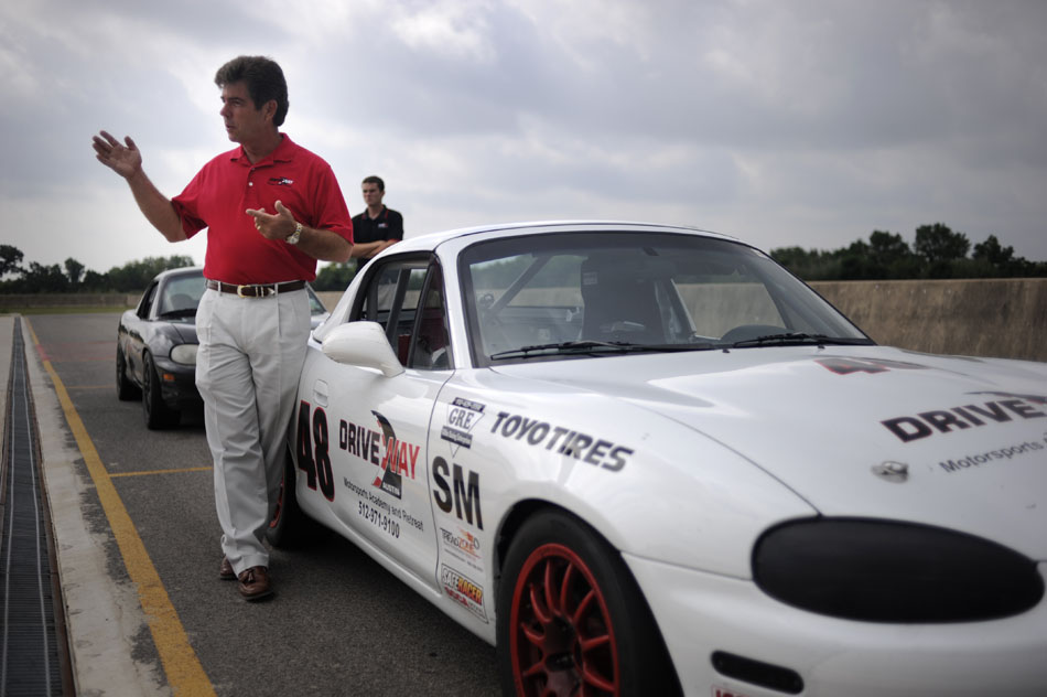 Driveway Austin president Bill Dollahite explains the cockpit of a Spec Mazda Miata racecar at the track on Wednesday, June 2, 2010. The 90 acre complex allows drivers to bring their street vehicles to the track for driving school lessons.