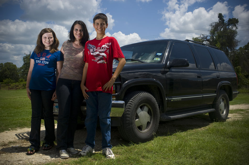 Angella Fuller, middle, poses with her daughter, Elizabeth, and son, Jackson, in front of the family's Chevrolet Tahoe at their Elgin home on Saturday, June 19, 2010. After Angelia had a seizure behind the wheel of the vehicle, Elizabeth, age 11, and Jackson, age 14, jumped to the rescue and safely stopped the vehicle.
