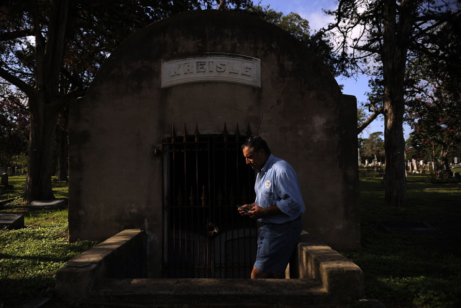 Dale Flatt, an organizer with Save Austin's Cemeteries, inspects an old crypt at Oakwood Cemetery on Wednesday, June 23, 2010.