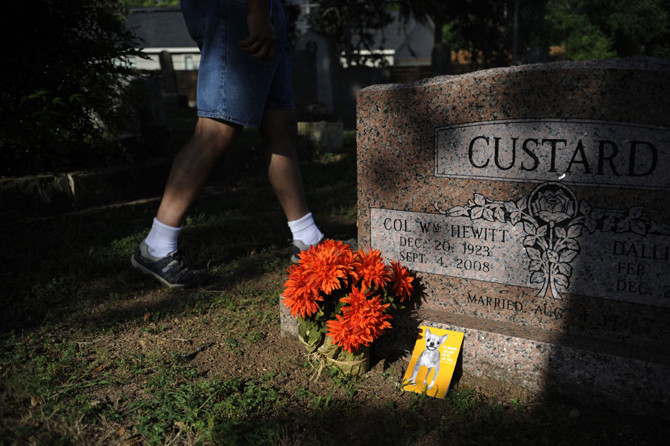 Dale Flatt, an organizer with Save Austin's Cemeteries, walks past a gravestone marked with flowers and a Father's Day card in an older section of Oakwood Cemetery on Wednesday, June 23, 2010.