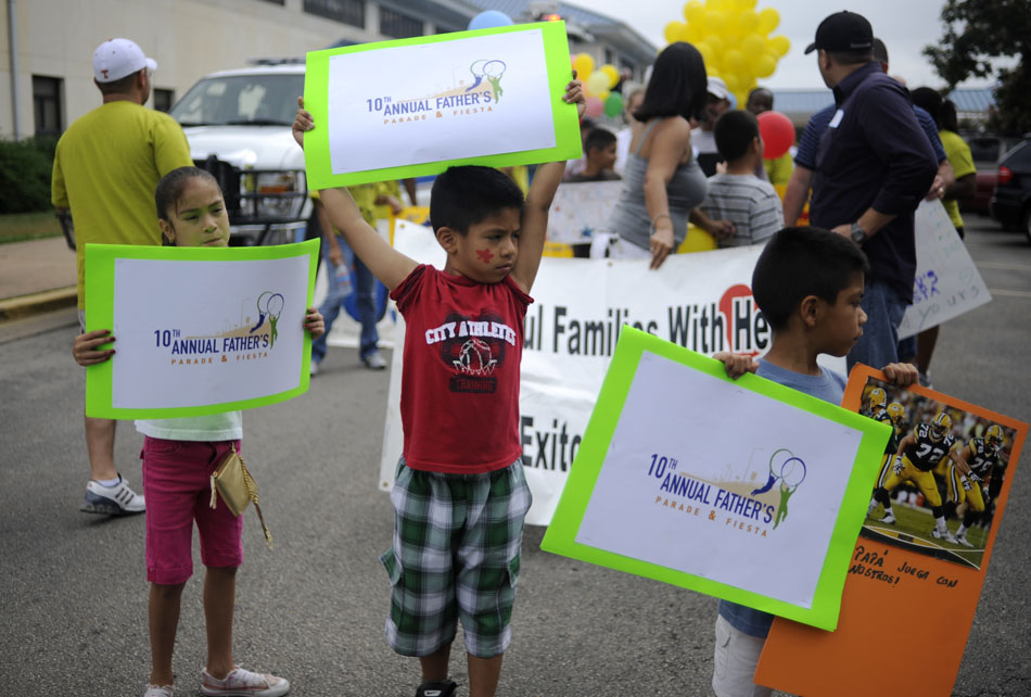 Audelio Auila, middle, age 6, holds a sign during the line up for the Father's Parade and Fiesta at Mendez Middle School on Saturday, June 5, 2010. The parade walked a few blocks to the River City Youth Foundation for food, games and entertainment.