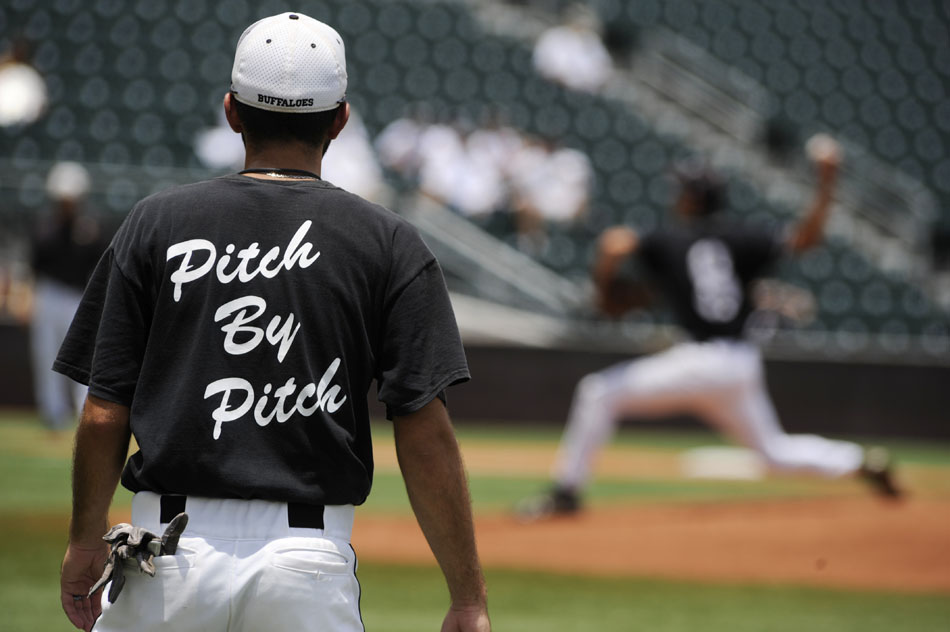 The Giddings baseball team slogan is seen on the back of a coach's shirt as a Pleasant Grove pitcher throws early in the Class 3A state championship game at Disch-Falk Field on Thursday, June 10, 2010.