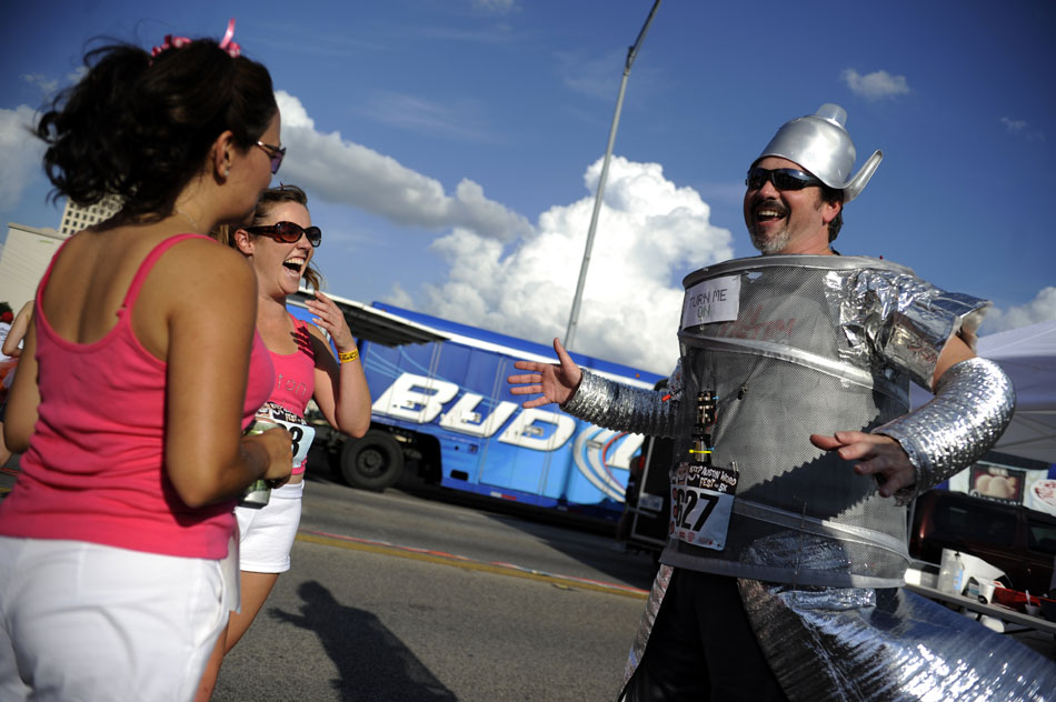 Greg Birch, right, shows off his robot costume before the start of the Keep Austin Weird 5K on Saturday, June 26, 2010.