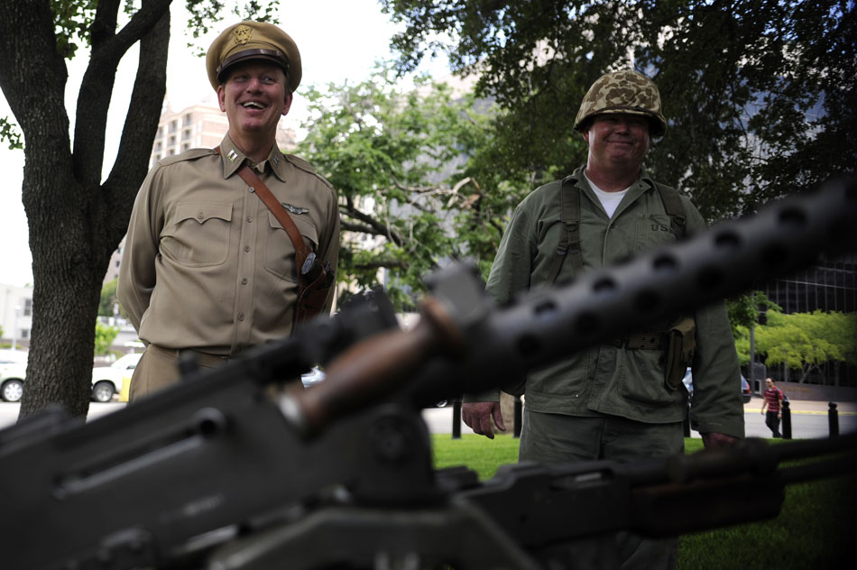 Jeff Hunt, director of the Texas Military Forces Museum, and Glen Villoz share a laugh with a visitor at a table displaying some Korean War era weapons and soldier items during a ceremony marking the 60th Anniversary of the start of the Korean War at the Texas Korean War Veterans Memorial on Friday, June 25, 2010.