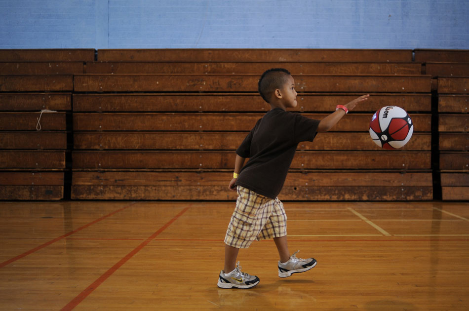 Javon Otis, age 6, partakes in a dribbling drill at a Police Activities League basketball camp at the East Boys and Girls Club on Wednesday, June 16, 2010. The camp included shooting, defense, dribbling and passing drills.