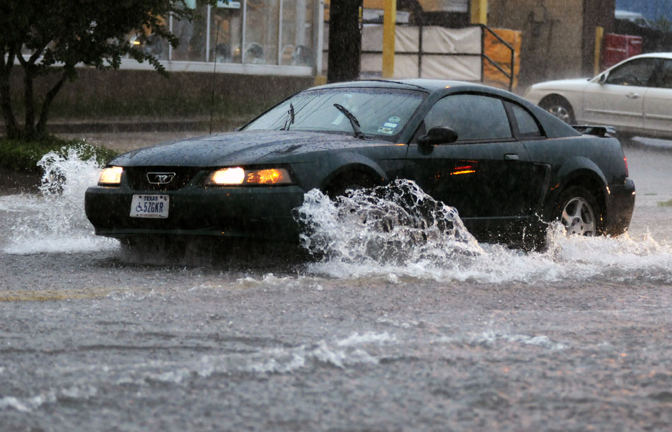 A motorist drives through a stretch of flooded road on Oltorf Street near the intersection with Congress Avenue on Tuesday, June 29, 2010. Heavy rains partially flooded streets and roads in several areas of Austin.