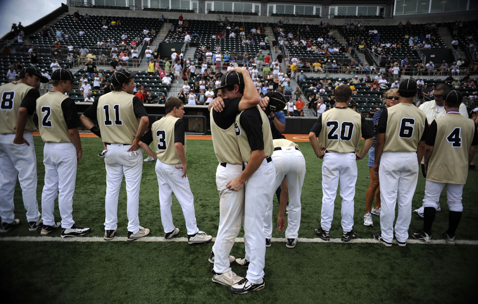 Bushland's Thomas Cleveland, left, and Rawley Gomez embrace as their team receives second place medals following a 6-1 loss to Rogers in the Class 2A state championship game at Disch-Falk Field on Thursday, June 10, 2010.