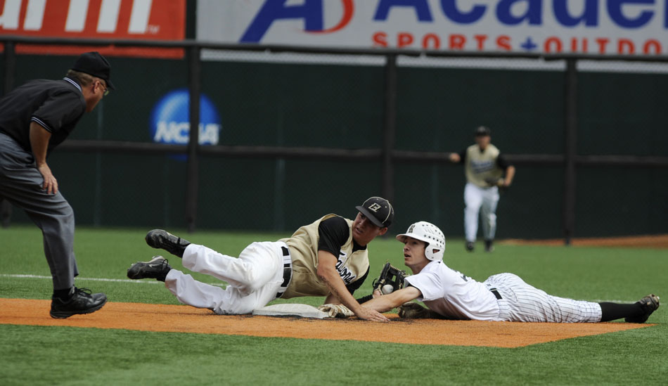 Bushland's Brett Wilhelm, left, waits for a call from the umpire after tagging Rogers'  Gregory Mendoza at second base during the Class 2A state championship game at Disch-Falk Field on Thursday, June 10, 2010.