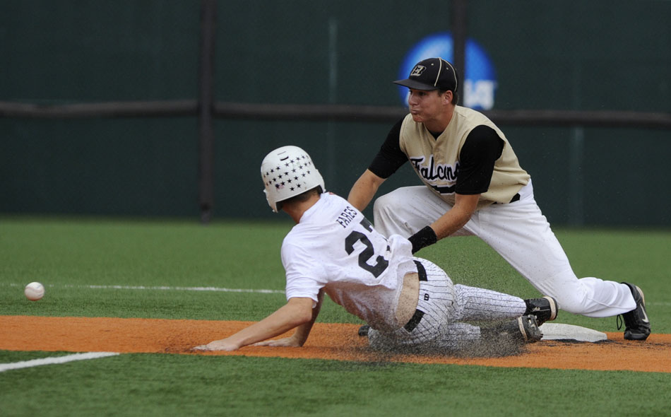 Rogers' Ryan Fares slides into second as Bushland's Brett Wilhelm awaits the throw during the Class 2A state championship game at Disch-Falk Field on Thursday, June 10, 2010.