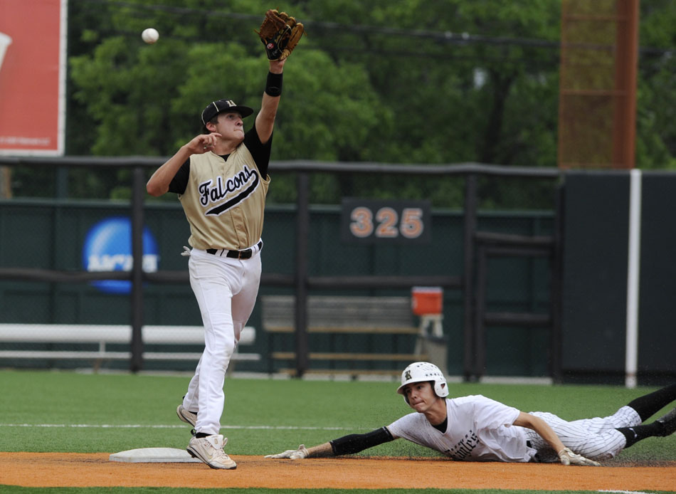 Bushland's Sterling Kiper stretches out as a throw to second sails over his head allowing Rogers' Gregory Mendoza to slide safely into the base during the Class 2A state championship game at Disch-Falk Field on Thursday, June 10, 2010.