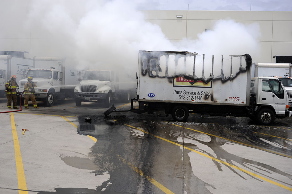 Austin firefighters battle a blaze in the back of a service parts truck in the parking lot of the Austin American Statesman on Tuesday, June 8, 2010.