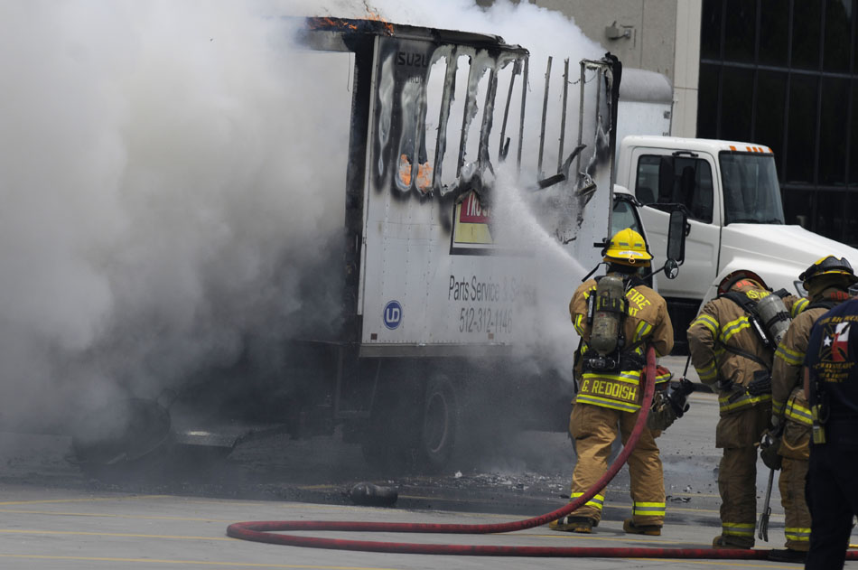 Austin firefighters battle a blaze in the back of a service parts truck in the parking lot of the Austin American Statesman on Tuesday, June 8, 2010.