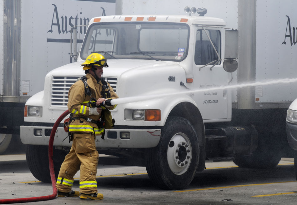 An Austin firefighter extinguishes a fire in the back of a service parts truck in the parking lot of the Austin American Statesman on Tuesday, June 8, 2010.