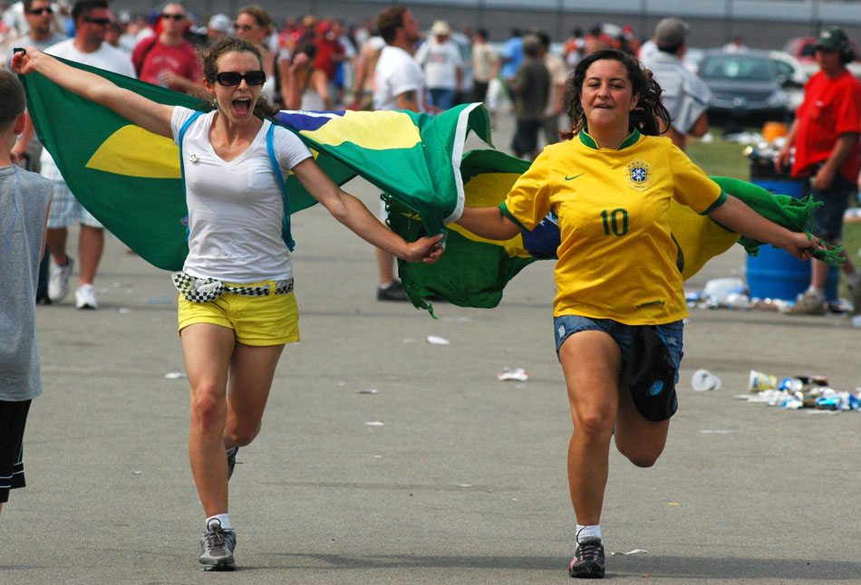 Elaine Delmoro, left, and Vanessa Danieli dos Santos celebrate after Brazilian Helio Castroneves won his third Indianapolis 500 on Sunday, May 24, 2009, at the Indianapolis Motor Speedway.