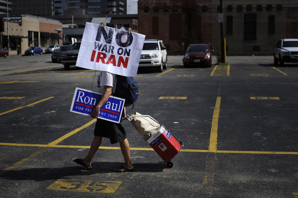A Ron Paul supporter makes his way along Third Street with an anti-war sign on Saturday, July 24, 2010.