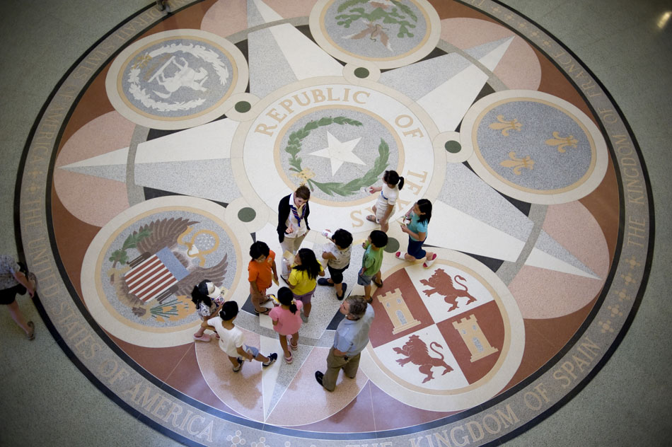 A tour guide leads a group of children on a tour of the Texas State Capitol rotunda on Wednesday, July 14, 2010.