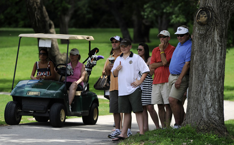 Danny Rienstra, third from right, gives a thumbs up to golfer Scott Roudebush as he prepares to putt on the first green during the final round of the Firecracker Open at Lions Municipal Golf Course on Sunday, July 4, 2010.