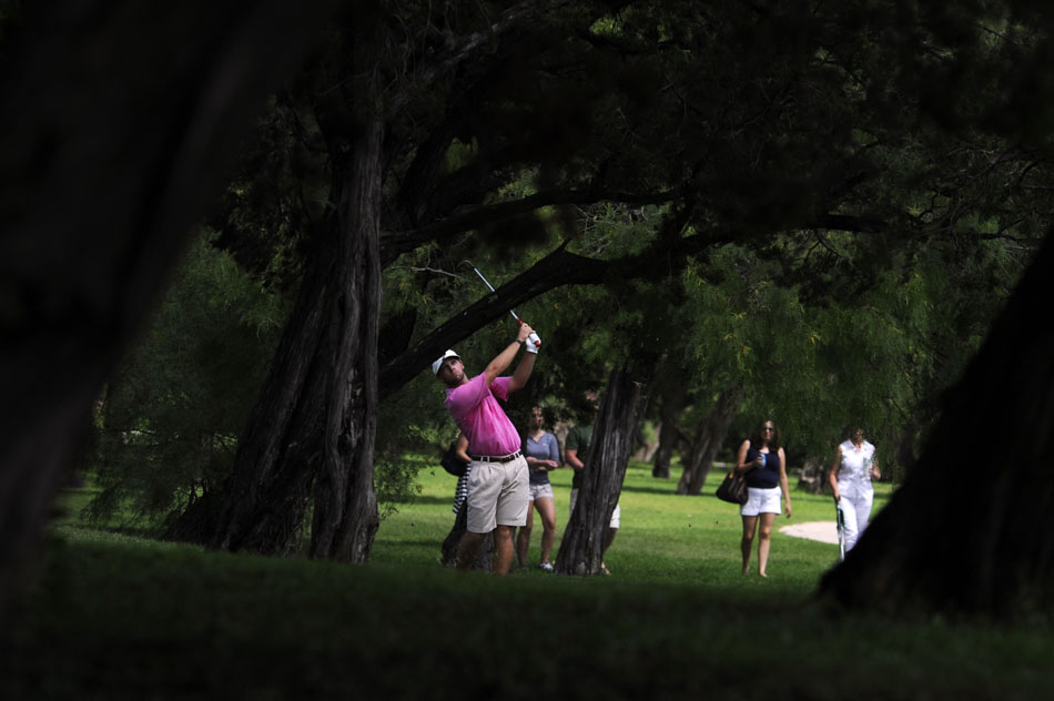 Cole Moreland watches the path of his shot from a wooded area during the final round of the Firecracker Open at Lions Municipal Golf Course on Sunday, July 4, 2010.