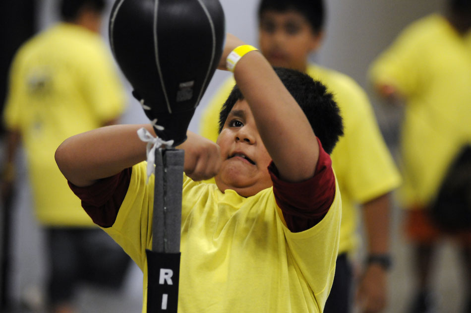 Abraham Anzurez, age 9, tries his hand at a speed bag during a Police Activities League boxing clinic at the Palmer Events Center on Monday, July 12, 2010.
