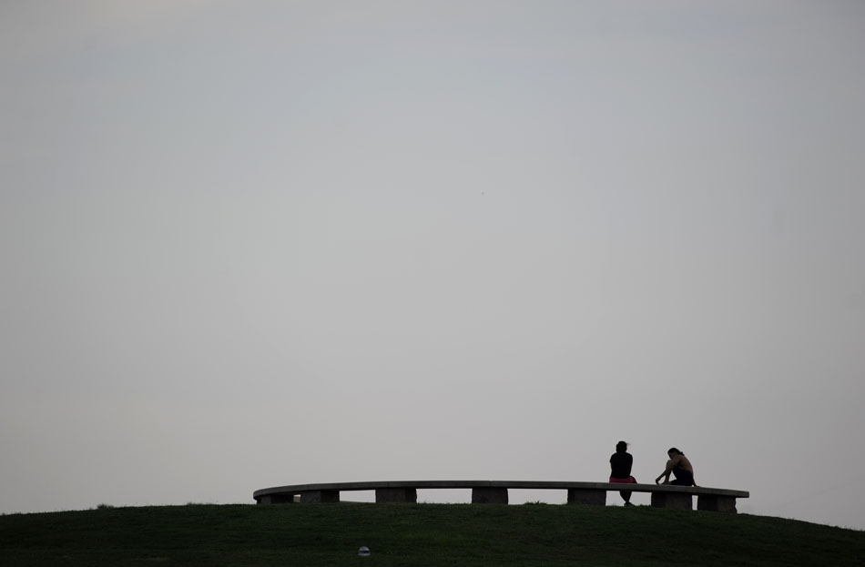 A couple take a break on top of the observation hill in Butler Park on Wednesday, July 7, 2010.