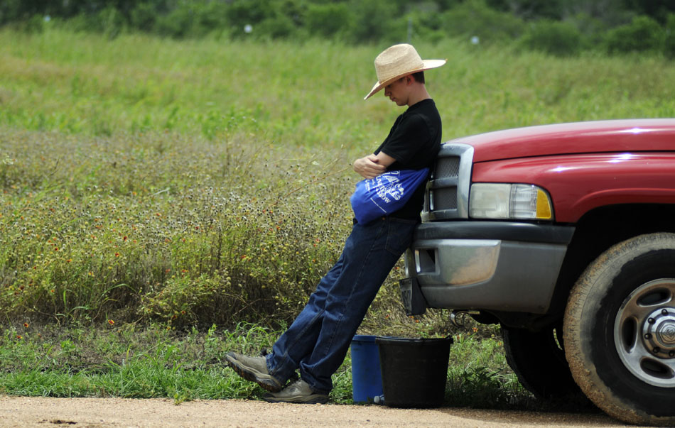 Jack Bartley waits by a truck at Pioneer Farms on Saturday, July 3, 2010. Bartley was helping with the horses that pull a wagon that takes visitors around the farms.