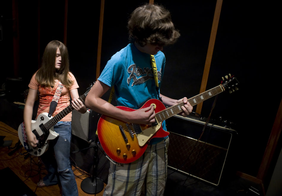 \Hatin' on the Hair rhythm guitarist Liv Bregger, age 13, and Mason Crowell, age 13, jam before recording with her band during Rock Camp USA at the Austin School of Music on Wednesday, July 21, 2010.