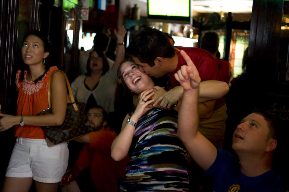 A Spanish fan gets a kiss watching the end of Spain's 1-0 win against the Netherlands at Fado Irish Pub on Sunday, July 11, 2010.