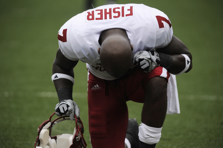 IU cornerback Ray Fisher bows his head in prayer before the start of a game against Michigan on Saturday, Sept. 26, 2009, in Ann Arbor, Mich.