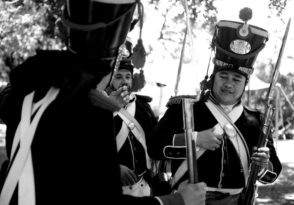 A re-enactor dressed as a Mexican soldier shares a laugh with  his comrades on Saturday, Aug. 7, 2010, at the Alamo in San Antonio, Texas.