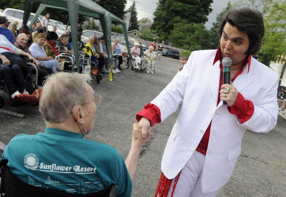 Elvis impersonator Tim Dudley reacts after Forrest F. wouldn't let go of his hand as Dudley greets the crowd during a performance for senior citizens on Friday, June 19, 2009, at the Milton Adult Day Services. Dudley performed several of Elvis' hits for the crowd.
