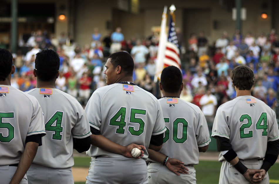 LumberKings pitcher Yoervis Medina (45) holds a baseball as he watches pre-game festivities with his teammates before taking on Peoria on Saturday, Aug. 28, 2010, at O'Brien Field.