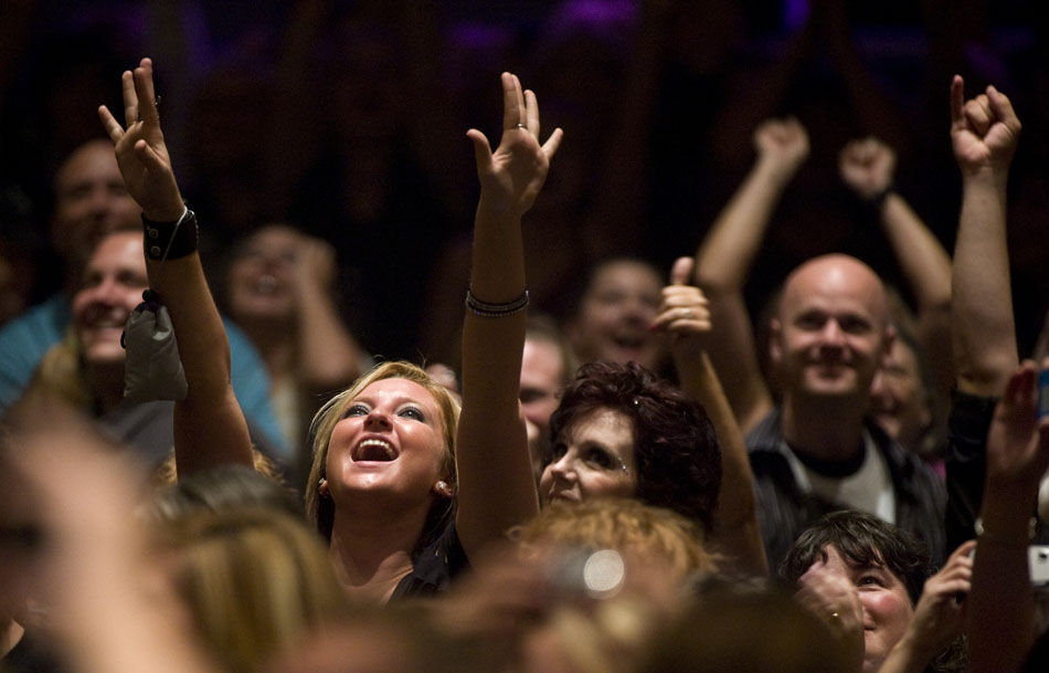 A fan cheers as a fellow fan dances to a Michael Jackson song in the balcony prior to an Adam Lambert concert on Sunday, Sept. 5, 2010, at the Peoria Civic Center.