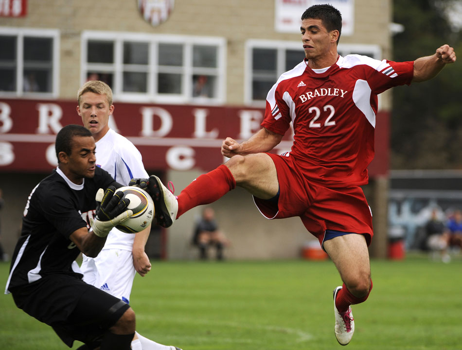 Bradley's Christian Meza (22) plays the ball into the box as SMU keeper Craig Hill, left, tries to stop the advance during a game on Saturday, Sept. 19, 2010, at Shea Stadium in Peoria. Meza advanced the ball past the keeper and scored Bradley's only goal on the play as the Braves lost 3-1.