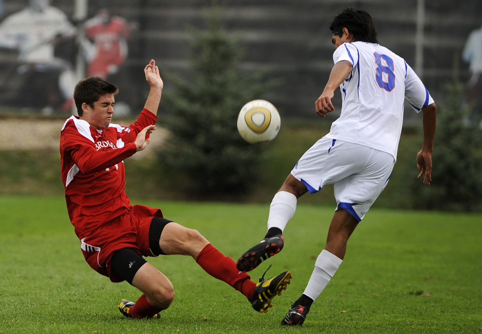 Bradley's Aodhan Quinn, left, slides to kick the ball away from SMU's Josue Soto during a game on Saturday, Sept. 19, 2010, at Shea Stadium in Peoria. SMU won 3-1.