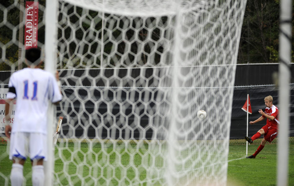 Bradley's Keith Mach kicks from the corner as SMU's Kekoa Osorio (11) waits in the goal during a game on Saturday, Sept. 19, 2010, at Shea Stadium in Peoria.