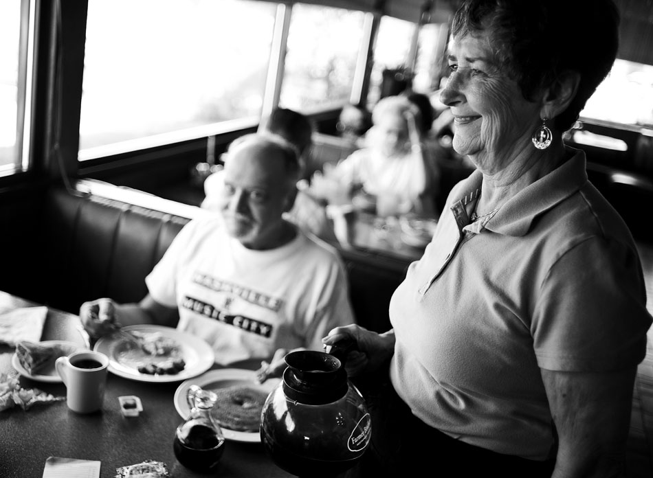 Martha Beaird, right, a waitress at Sterling Family Restaurant, talks with a patron after serving coffee for Rick Motsinger on Monday, Sept. 20,  2010, at the restaurant. Recent storms in South America has driven coffee prices up about 10 percent nationwide as producers' supplies have dwindled.