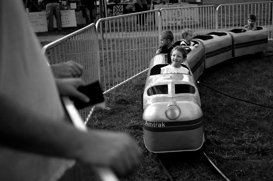Oliver Thornton, age 3, rides a miniature Amtrak train as his parents cheer him on during the Fall Festival on Thursday, Sept. 9, 2010, in Elmwood, Ill.